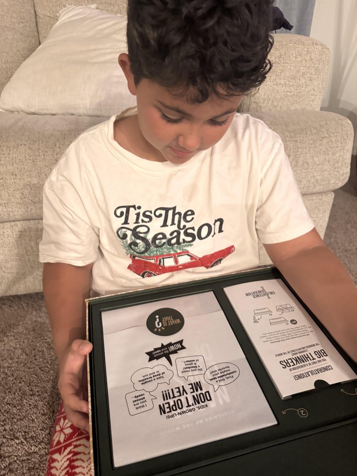 A boy looking into an open Enlightened Generation gift box