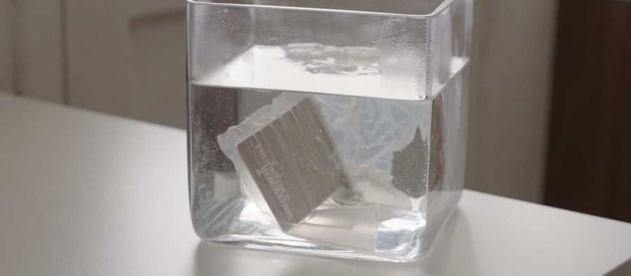 The bag dissolving in a glass of water