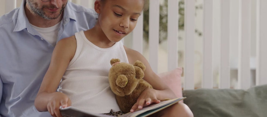 A dad and daughter reading the book together