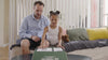 A father and daughter unboxing an Enlightened Generation gift box